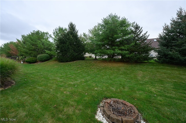 view of yard with an outdoor fire pit