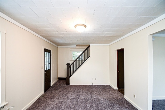 empty room with dark carpet and crown molding