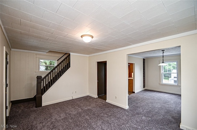 basement with dark colored carpet and ornamental molding