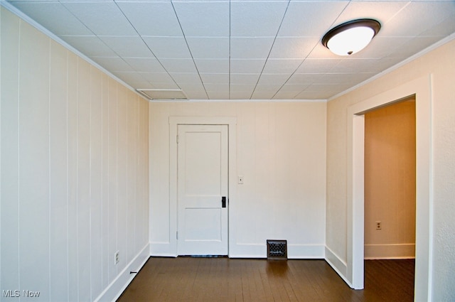 spare room with dark hardwood / wood-style flooring and ornamental molding