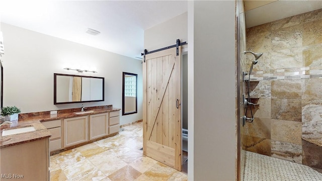 bathroom featuring vanity and tiled shower