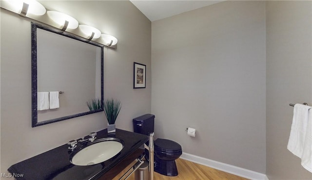 bathroom featuring hardwood / wood-style flooring, vanity, and toilet