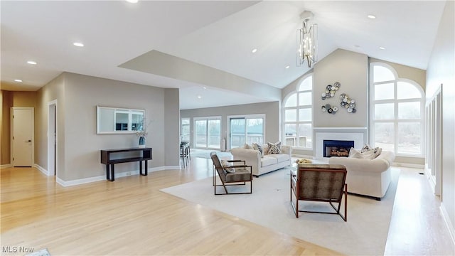 living room featuring a chandelier, light hardwood / wood-style flooring, and a wealth of natural light