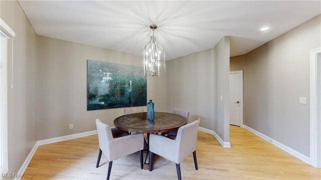 dining room featuring a chandelier and light hardwood / wood-style flooring