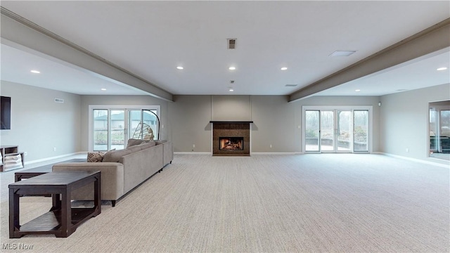 living room with beamed ceiling and light carpet