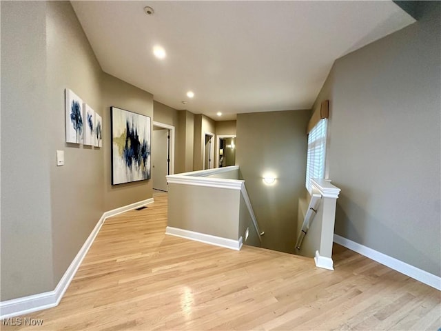 corridor with light wood-type flooring