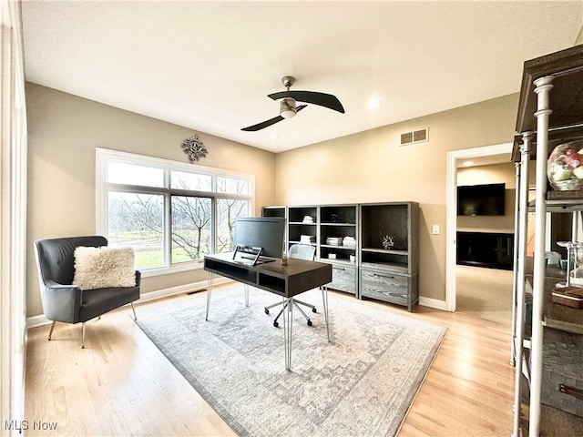 office area with light hardwood / wood-style floors and ceiling fan