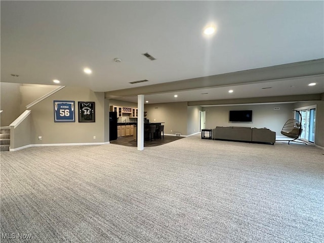 unfurnished living room with light colored carpet