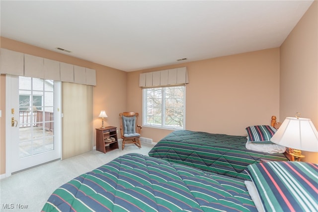 carpeted bedroom with access to outside