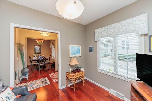 interior space featuring dark hardwood / wood-style floors and an inviting chandelier