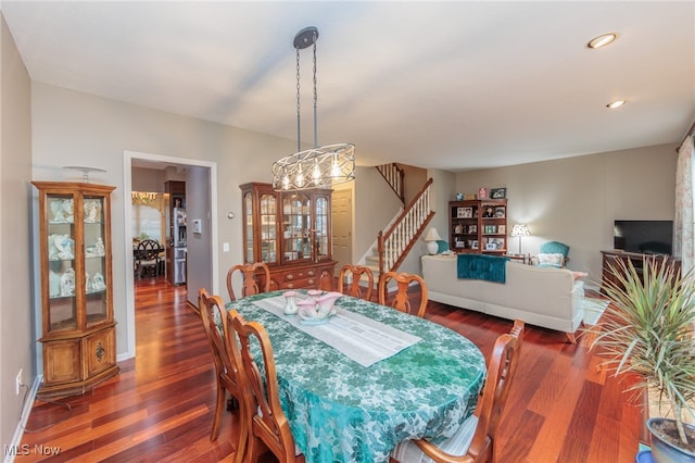 dining area featuring a chandelier and dark hardwood / wood-style flooring