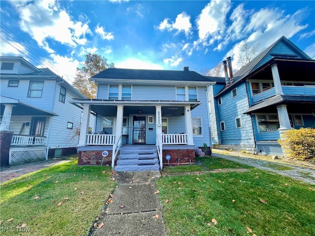 bungalow-style house featuring a porch and a front lawn