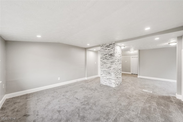 basement featuring carpet and a textured ceiling