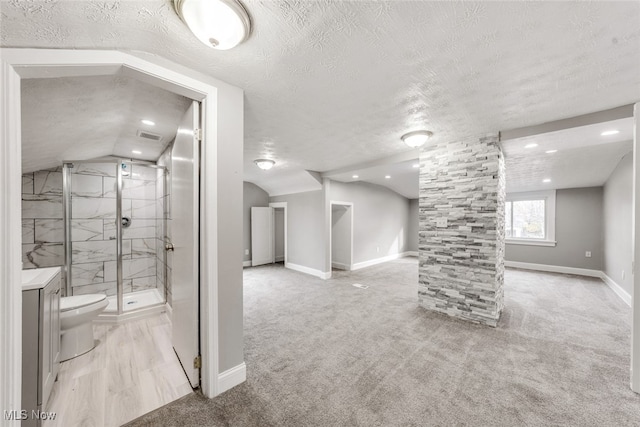 interior space featuring a textured ceiling and light colored carpet