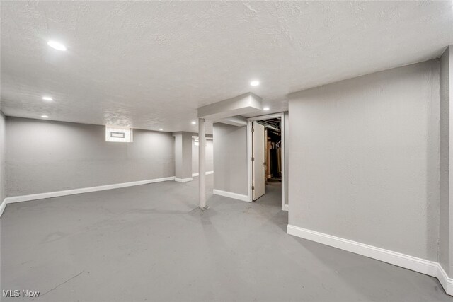 basement featuring a textured ceiling