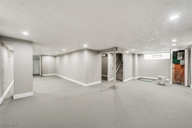 basement featuring a textured ceiling