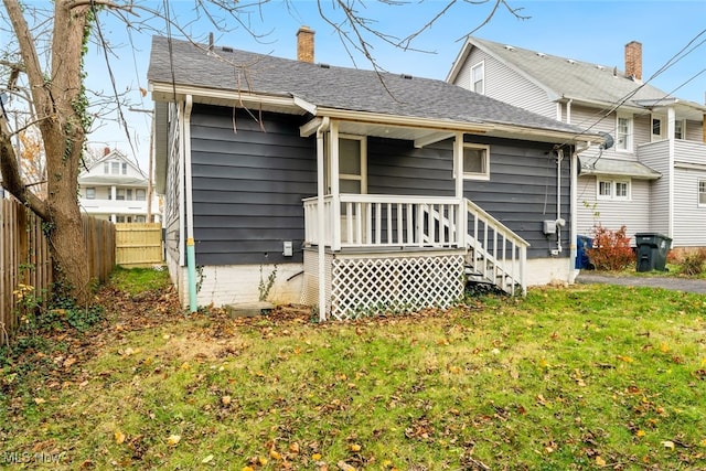 rear view of house with a lawn