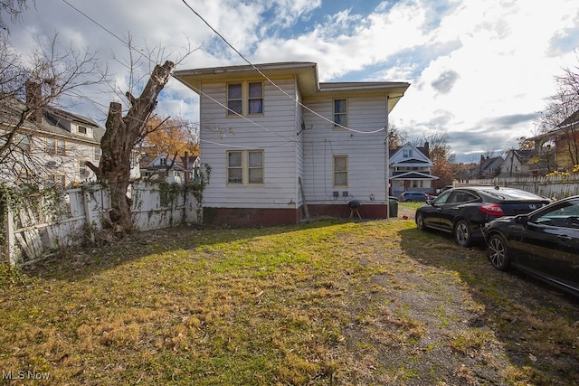 back of property featuring a lawn