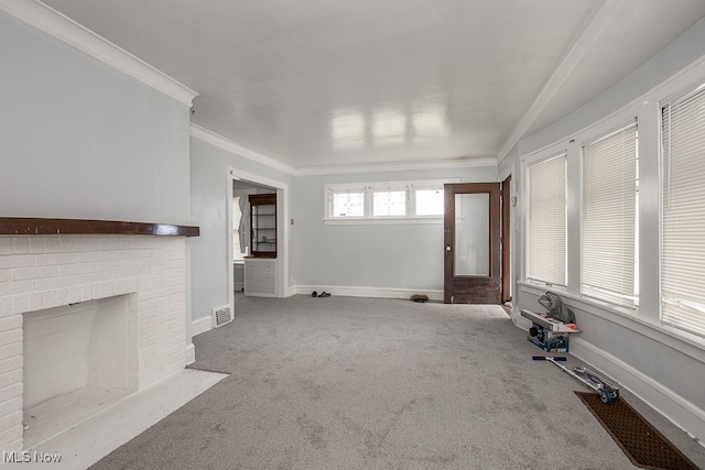 unfurnished living room with crown molding, light colored carpet, and a brick fireplace