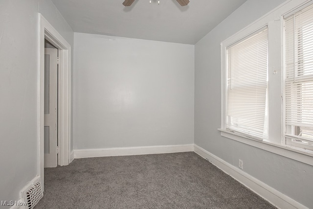 carpeted spare room with ceiling fan