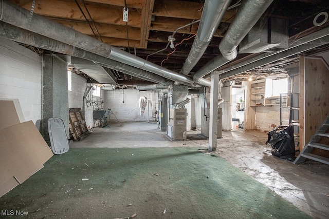 basement featuring heating unit and sink