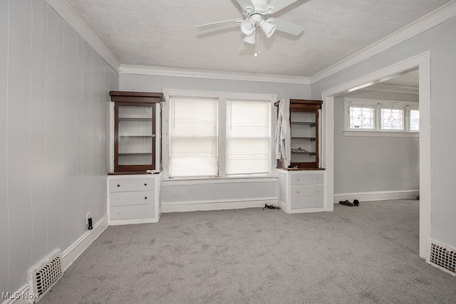 interior space featuring light carpet, crown molding, and ceiling fan