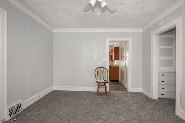 carpeted spare room featuring ceiling fan, crown molding, and a textured ceiling