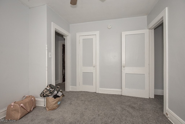 unfurnished bedroom featuring ceiling fan and carpet floors