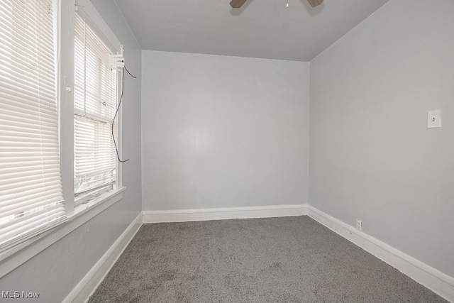 spare room with ceiling fan and carpet