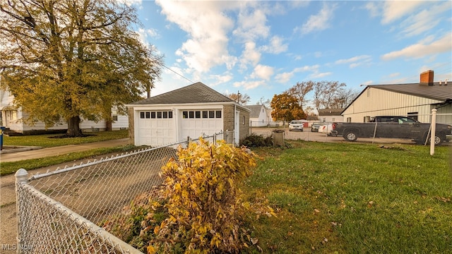 view of side of property with a yard, a garage, and an outdoor structure