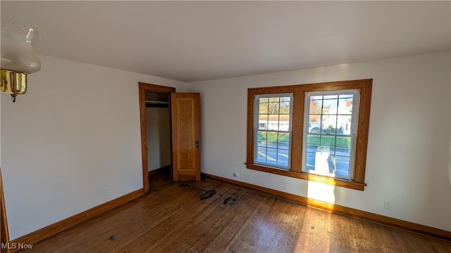 spare room featuring dark wood-type flooring