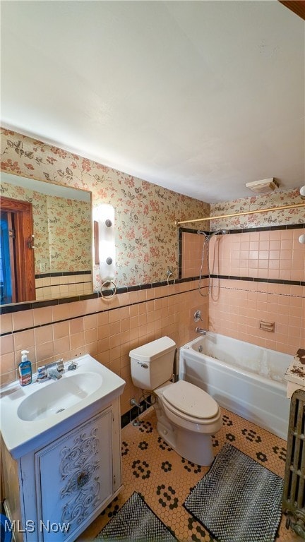 full bathroom with tile patterned floors, vanity, shower / bathing tub combination, tile walls, and toilet