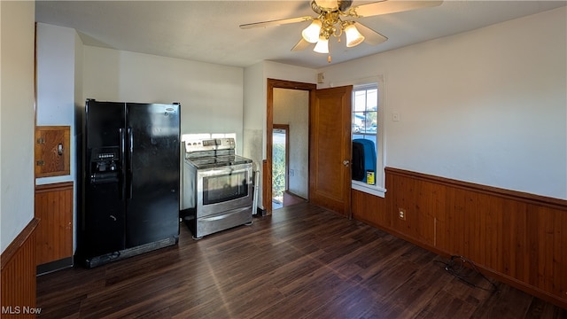 kitchen with black refrigerator with ice dispenser, wooden walls, dark hardwood / wood-style floors, and stainless steel range with electric stovetop