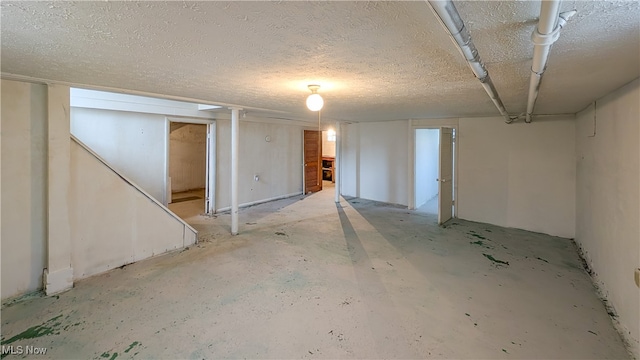 basement featuring a textured ceiling