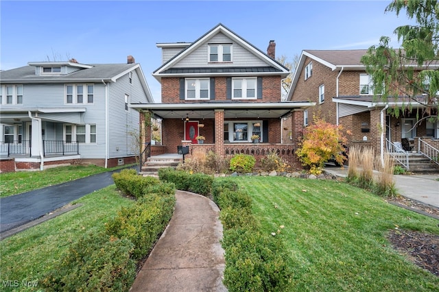 view of front of property with a porch and a front yard