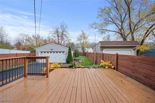 wooden deck with a garage and an outdoor structure