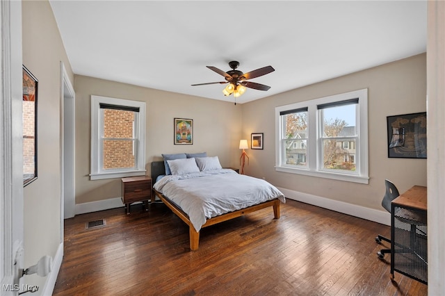 bedroom featuring ceiling fan and dark wood-type flooring