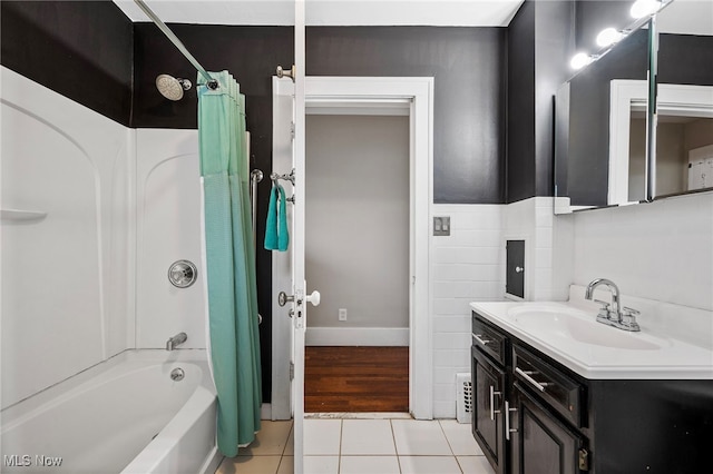 bathroom with tile patterned flooring, shower / bath combo, and vanity