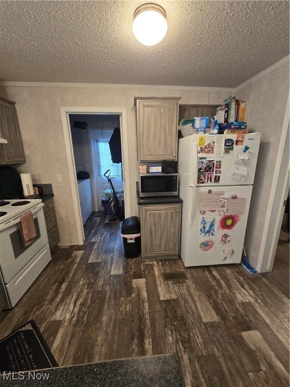 kitchen with a textured ceiling, white appliances, and dark hardwood / wood-style floors