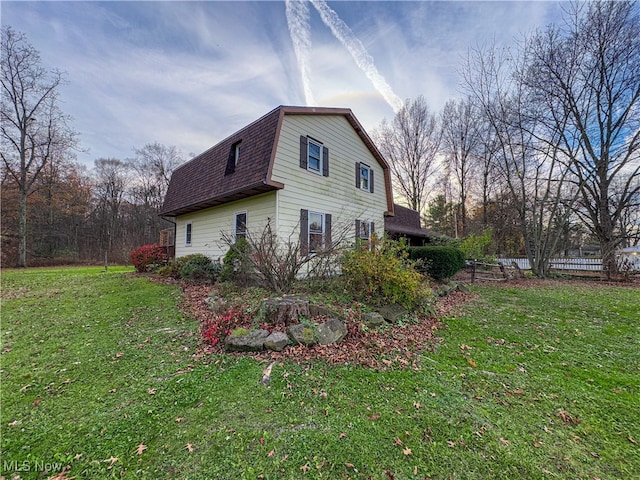 view of side of home featuring a yard