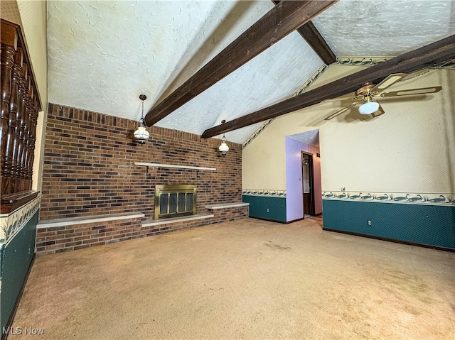 unfurnished living room with vaulted ceiling with beams, carpet floors, a textured ceiling, and a brick fireplace