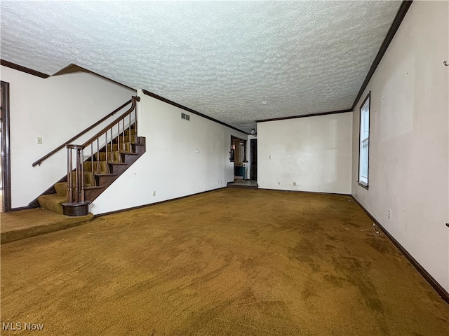 unfurnished living room featuring carpet, ornamental molding, and a textured ceiling