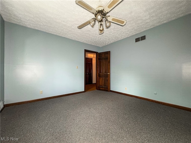 spare room featuring ceiling fan, carpet floors, and a textured ceiling