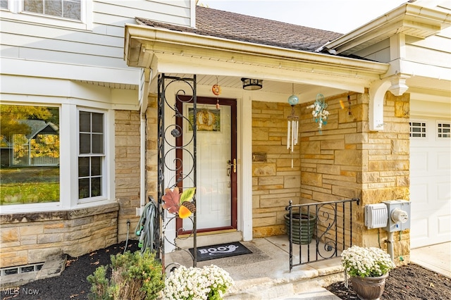 doorway to property with a garage