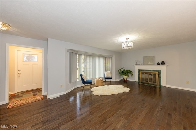 unfurnished room featuring a fireplace and dark hardwood / wood-style flooring