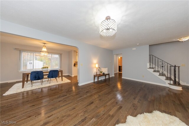 living room with a chandelier and dark hardwood / wood-style floors