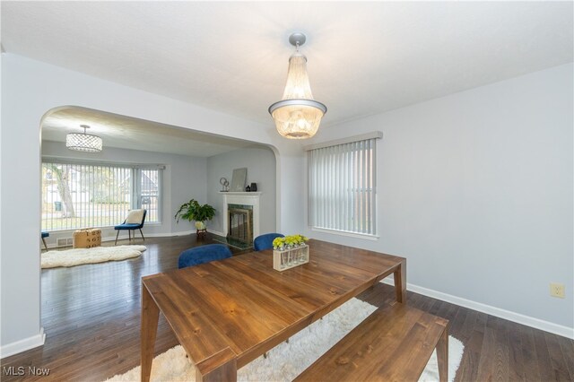 dining area featuring dark wood-type flooring