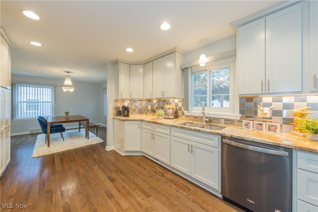 kitchen featuring dishwasher, pendant lighting, dark wood-type flooring, and sink