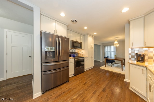 kitchen featuring tasteful backsplash, white cabinetry, dark hardwood / wood-style flooring, and stainless steel appliances