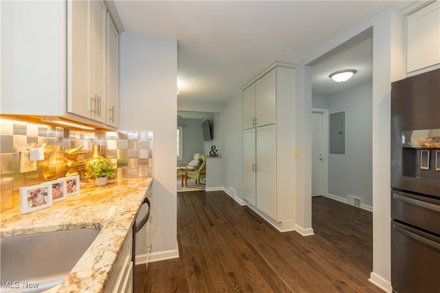 kitchen with light stone countertops, backsplash, black refrigerator with ice dispenser, white cabinets, and dark hardwood / wood-style floors